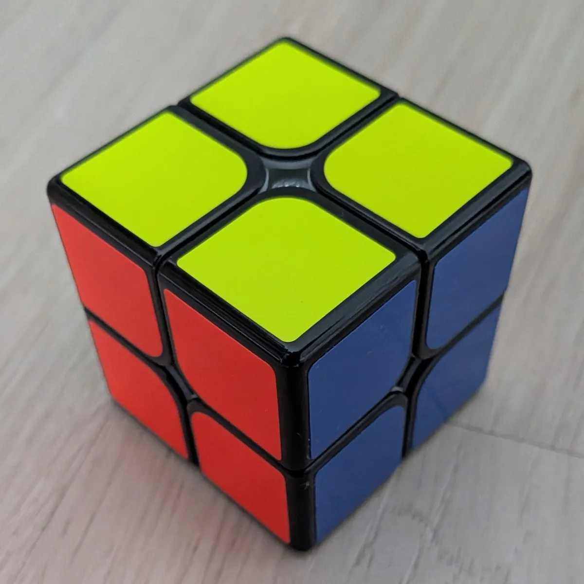 Un cubo de Rubik de 2x2 resuelto, con la cara amarilla arriba, la roja al frente y la azul a la derecha
