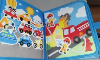 Un libro de fieltro abierto por la página de los vehículos, con el camión de bomberos, el taxi y el coche de policía despegables