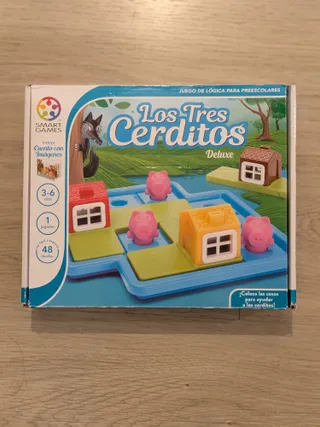 La caja de Los Tres Cerditos Deluxe, de SmartGames, con el tablero azul, las casas de colores y los cerditos de plástico